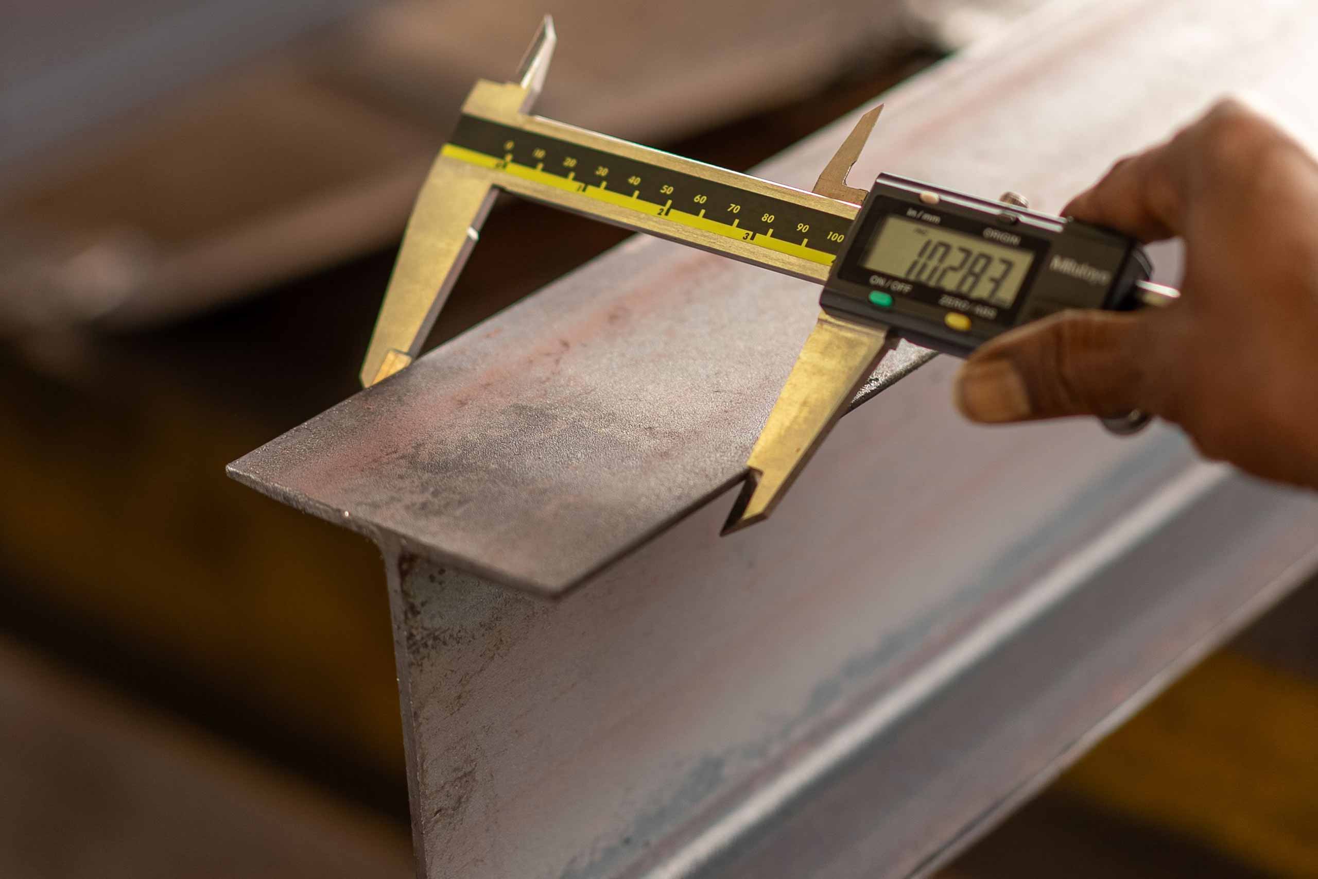 Industrial caliper measuring metal part